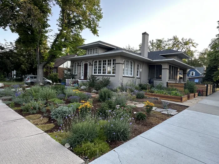 The same bungalow with the lawn replaced by flagstone steppers, perennials and grasses.